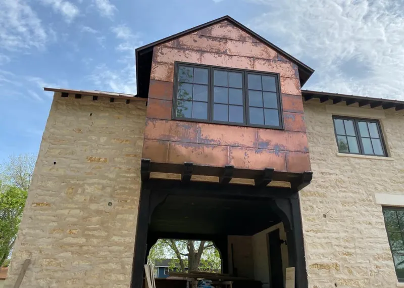 Copper metal panel facade on a stone building for Roof Repair in Coconut Creek